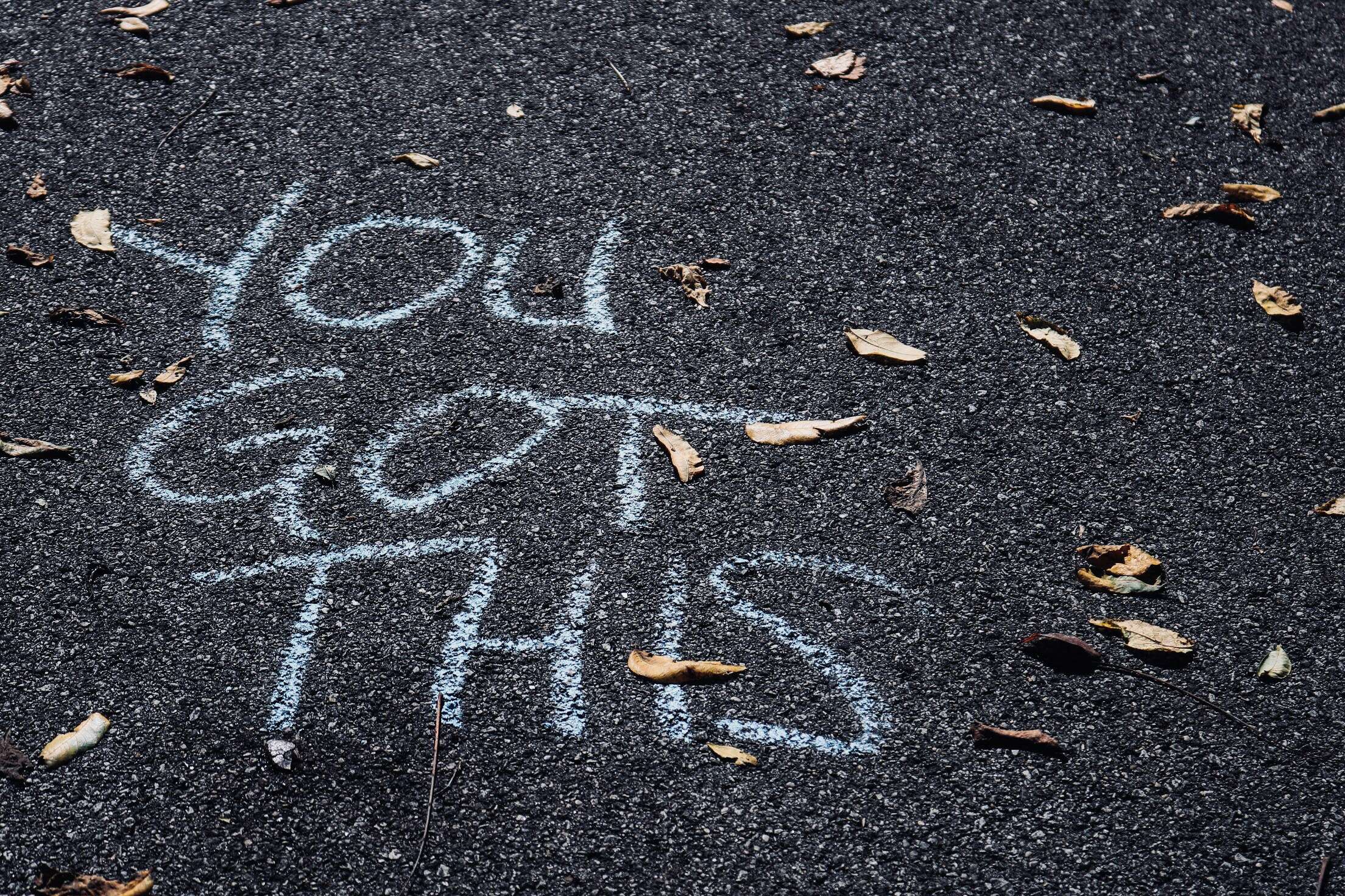 Motivational message written in chalk on pavement that reads 'You Got This,' surrounded by scattered leaves. The image conveys encouragement and positivity, emphasizing the importance of mindset in achieving mental and physical health goals through exercise.